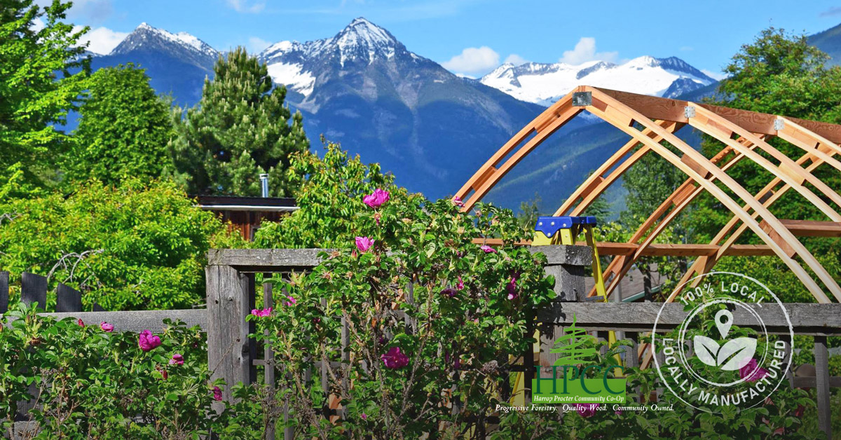 Beautiful image of an Argenta Greenhouse being constructed at the base of the Purcell Mountains